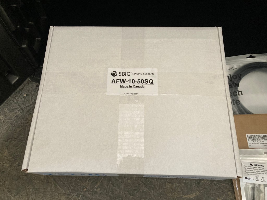 A boxed SBIG AFW-10-50SQ 50mm Square AFW Filter Wheel.